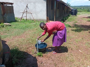 Getting-water-from-the-new-system-at-Kubar-school