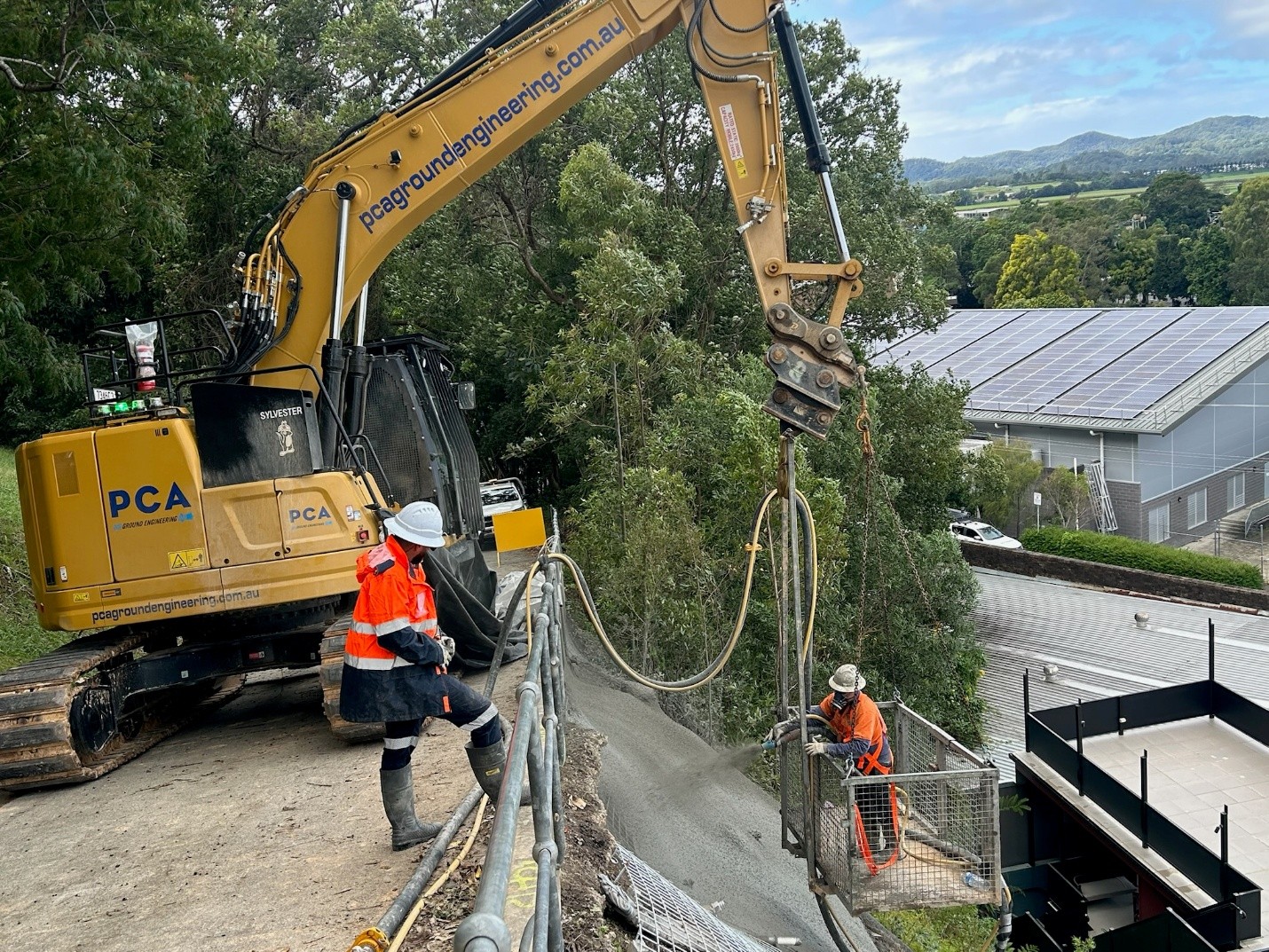 Contractors spray shotcrete onto the bank at Church Street, Murwillumbah.