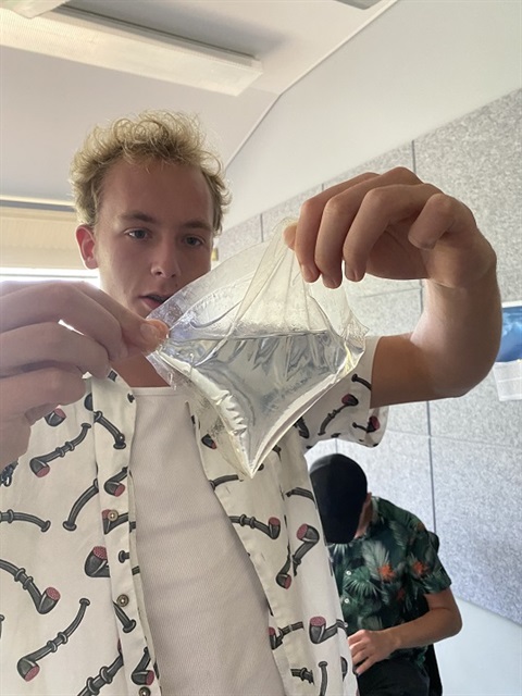 Student holding up seaweed bioplastic bubble